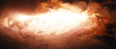 Two figures facing each other, firing bright beams of light through a massive explosion of fire and smoke.