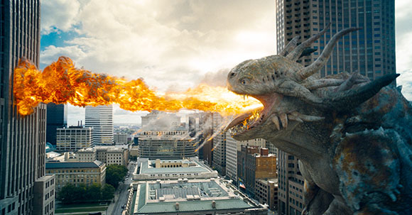 A massive scaly dragon breathes a stream of fire across a cityscape between tall buildings.