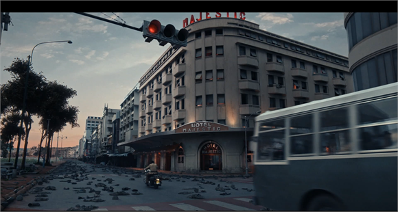 A street scene featuring the Hotel Majestic building and a blurred bus passing in the foreground.
