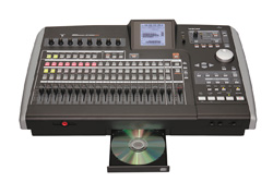 A black digital audio mixing console with various sliders, buttons, and a small screen, featuring an open CD tray.