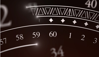 Close-up of a dark, stylized clock face showing numbers 57 through 3.