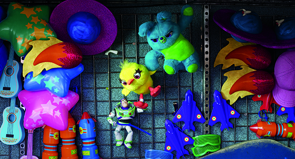 Various colorful toys including stuffed animals, hats, inflatable stars, and toy planes on a wire rack.