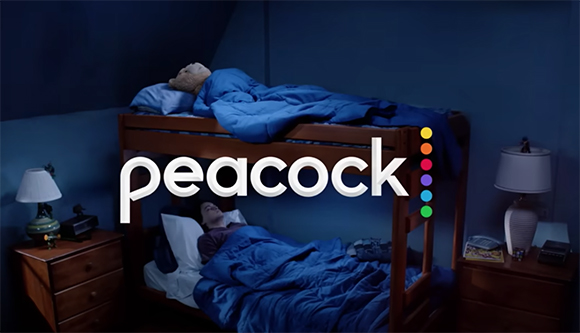 The white Peacock logo is centered over a dark room featuring wooden bunk beds with blue bedding.