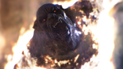 A dark, snarling creature with sharp teeth emerging from bright orange and white flames.