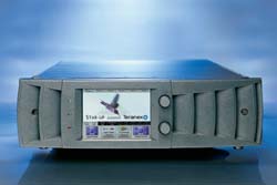 A silver rack-mounted electronic device with a small digital screen displaying a bird and text.