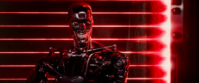 A chrome robotic skull and torso illuminated by glowing red horizontal laser lines.
