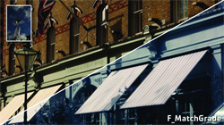 A split image showing a brick building facade with awnings, one side in warm tones and the other in cool blue tones.