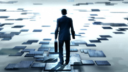 A man in a suit carrying a briefcase walks across floating rectangular tiles toward a bright light.