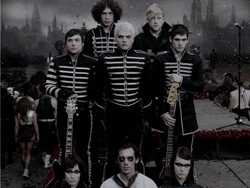 Five men in black jackets with white horizontal stripes posing in a dark, atmospheric setting.