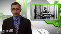 A man in a dark suit and blue tie stands beside an inset black and white photo of a man behind prison bars.