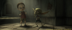 A small human child and a green, large-eared creature stand facing each other in a dim, stone hallway.