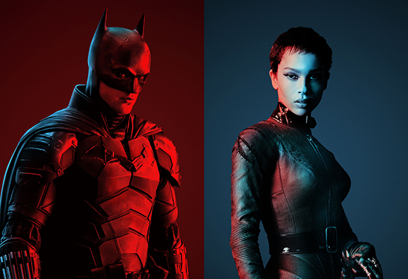 Batman in dark armor on the left and a woman in a dark catsuit on the right, split by red and blue lighting.