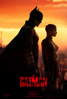 Silhouettes of Batman and Catwoman standing against a bright orange sunset sky.