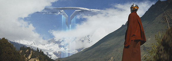 A person in a red cloak watches a large, white, Y-shaped spacecraft hovering above snowy mountains.