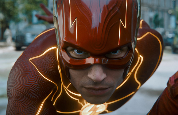 Close-up of a man wearing a red superhero mask and suit with glowing yellow accents.