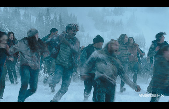 A crowd of people running through a snowy, forested landscape under a blue tint.