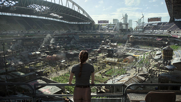 A woman with a long braid stands on a balcony overlooking a dense, makeshift city inside a large stadium.