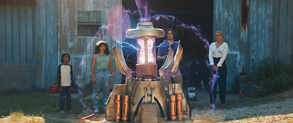 Four people stand around a central mechanical device emitting purple light and energy arcs.