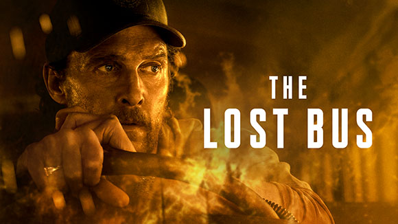 A man in a baseball cap looks intensely forward amidst smoke and fire, with the title THE LOST BUS.
