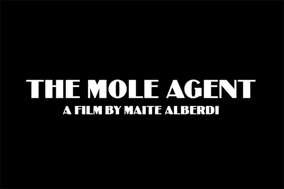 White text on a black background reads 'THE MOLE AGENT' and 'A FILM BY MAITE ALBERDI'.