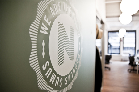 A white circular logo with the text 'WE ARE THE NATION POPULUS SUMUS' and a large letter N in the center.