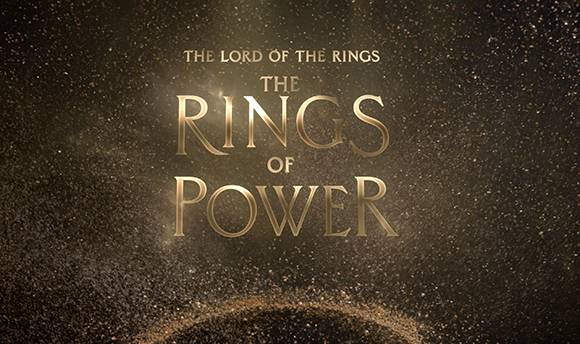 Gold text reading The Lord of the Rings: The Rings of Power against a sparkling gold background.
