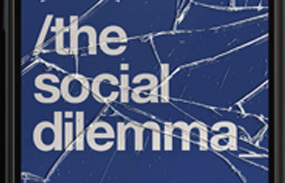 White text reading 'the social dilemma' over a dark blue background with cracked glass patterns.