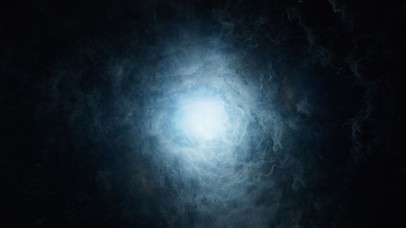 A bright white light shining through thick, dark blue swirling clouds and mist.