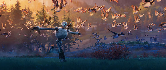A small robot runs through a grassy field under a sky filled with many flying birds at sunset.