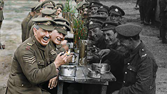 A color photo on the left and a black-and-white photo on the right show soldiers in uniform sitting at a table.
