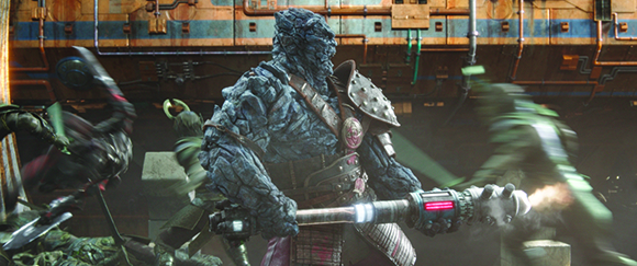 A large, grey, stone-textured creature holds a glowing mechanical staff amidst a chaotic battle.