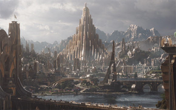 A vast sci-fi city featuring a towering golden central spire surrounded by smaller structures and mountains.