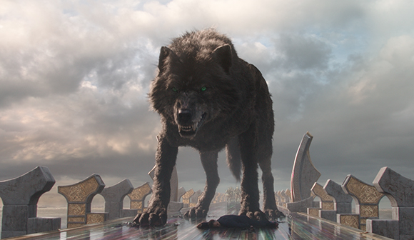 A large, dark-furred wolf with glowing green eyes stands on a stone bridge under a cloudy sky.