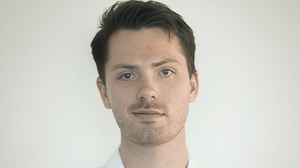 A headshot of a young man with short brown hair looking forward against a plain white background.