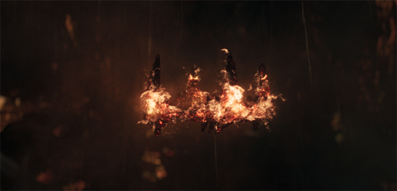 A crown made of glowing embers and flames floating against a dark, blurry background.