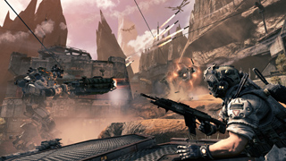 A soldier aims a rifle toward a large mech and explosions in a rocky, futuristic canyon landscape.