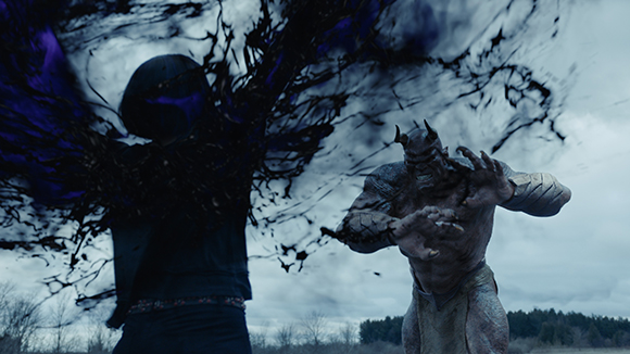 A dark, shadowy figure with purple energy stands next to a large, muscular, grey-skinned creature.