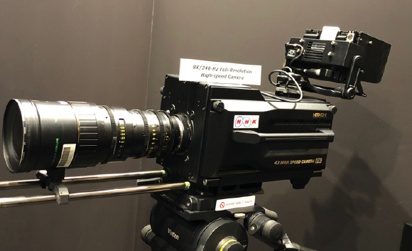 A black Hitachi 8K/240-Hz full-resolution high-speed camera with a large lens mounted on a tripod.