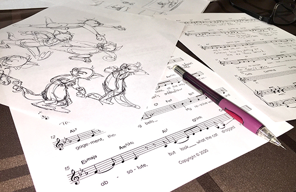 Black and white character sketches, musical notation sheets, and a purple mechanical pencil on a table.