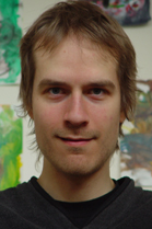 A man with light brown hair and blue eyes looking directly at the camera.