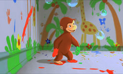 Animated brown monkey walking in a room filled with colorful paint splatters and floating bubbles.