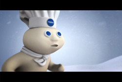 A white, dough-like character with blue eyes wearing a white chef's hat and neckerchief.