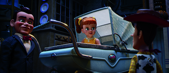 An animated male doll in a suit, a female doll in a baby carriage, and a male doll in a cowboy hat.