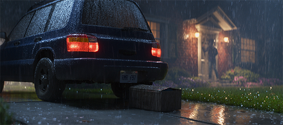A dark blue car parked in a wet driveway at night during heavy rain near a lit house.