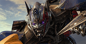 Close-up of a large, metallic blue and silver robot with glowing purple eyes.