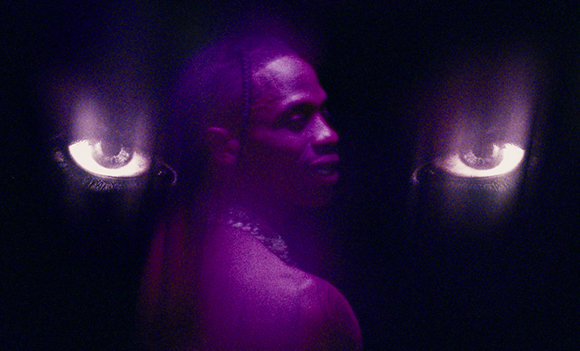 A person's silhouette in purple light overlaid with two large, glowing eyes on either side.