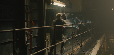 A person with white hair swings a hammer, surrounded by blue energy trails on a dark industrial platform.