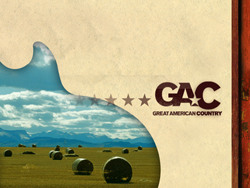 GAC Great American Country logo over a landscape of hay bales in a field under a cloudy sky.