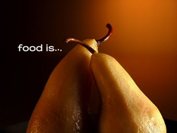 Two pears leaning together against a warm, dark orange background with the text 'food is...' on the left.