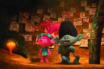 Two animated trolls, one pink and one grey, stand in a cave filled with sketches and red string.